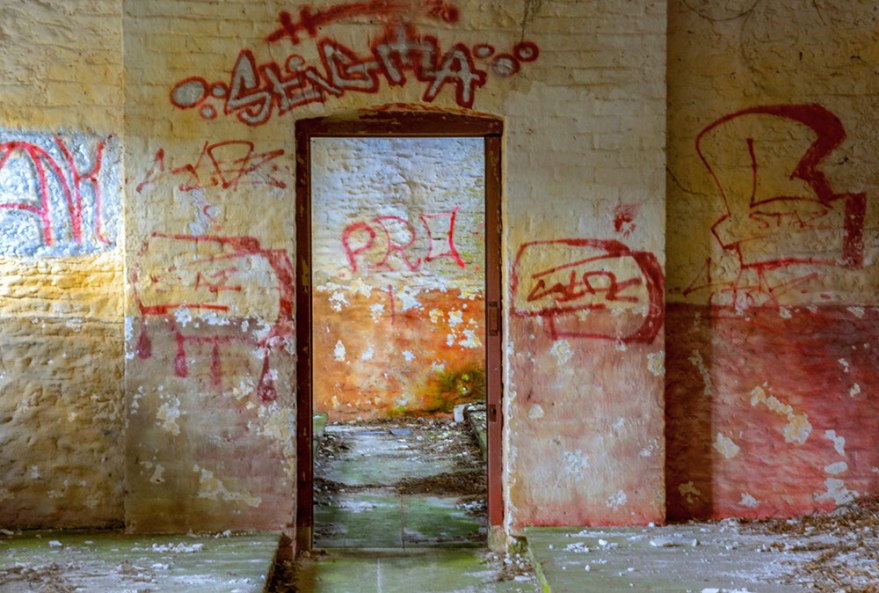 Graffiti above door in workhouse