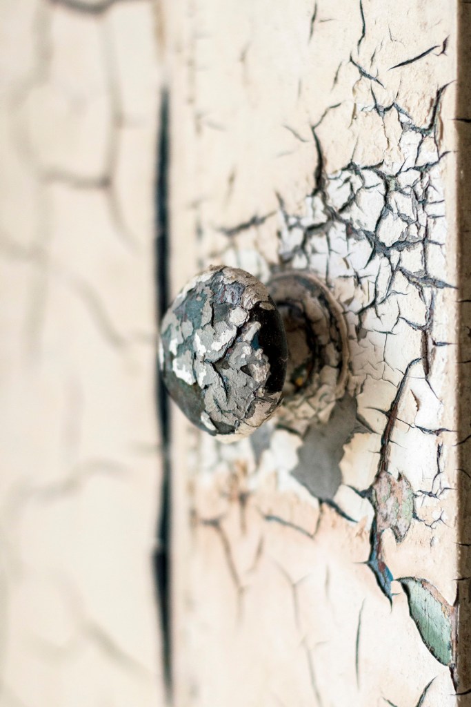Peeled paint on doorknob - Stories That Remain Untold exhibition